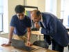dae student Emeka Oguagha explains a quantum algorithm he developed to Vivek Ramakrishnan, QuantumCT’s Senior Director of Technology Deployment. 