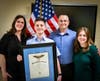 Cadet Second Lieutenant Caleb Eyler proudly displays his General Billy Mitchell Award, with his family. 