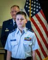 Cadet Second Lieutenant Caleb Eyler stands to be recognized by his peers.