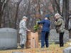 Cadet Technical Sergeant Erin Travers removes wreath to lay of veteran's grave. Also pictured are Cadet Zac Conger and Senior Member Mary Beth Bushall.