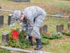 Cadet Airman Zac Conger places wreath in front of headstone.