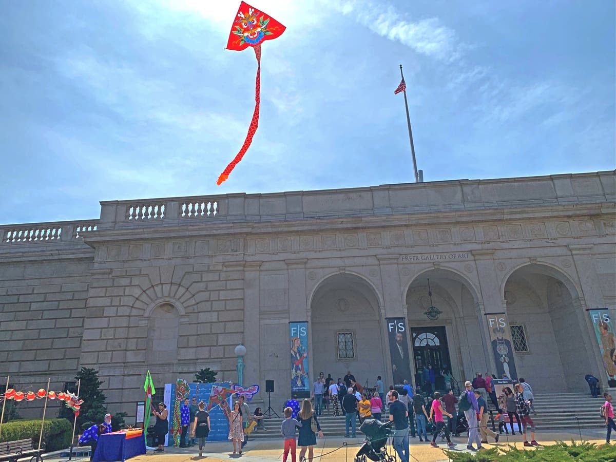 People flying and admiring Chinese-themed kites at the Smithsonian
