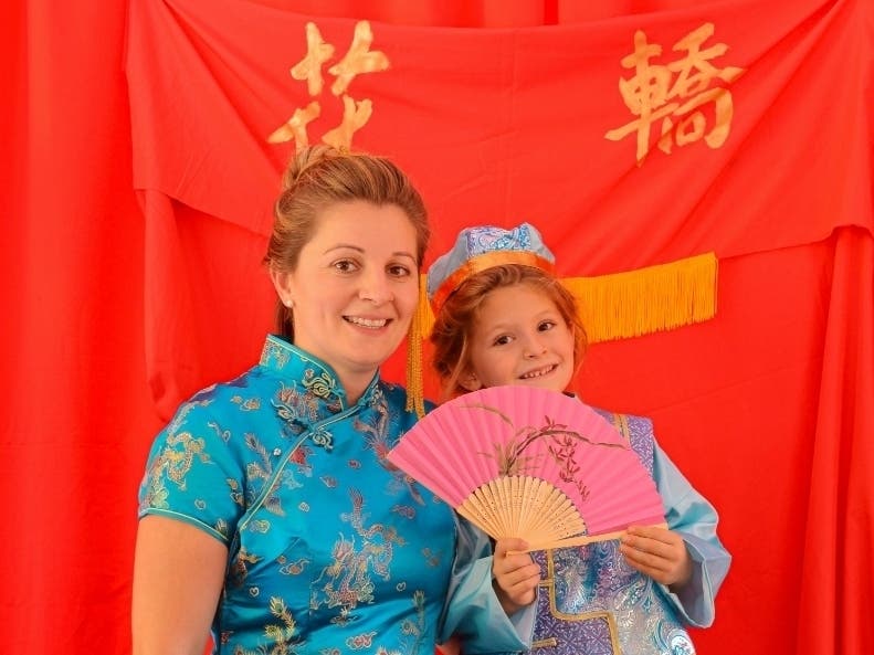 Mother and daughter trying on Traditional Chinese clothing