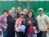 Group photo of the organizers and some participants of the professional women's charity tennis tournament.