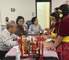 Mr. Zhonghou Yu (Volunteer) wrote the children's Chinese names on bookmarks using calligraphy based on their pronunciation.