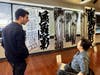 CCACC Executive Director Lewi explained the significance of the calligraphy artworks to Delegate Vogel.