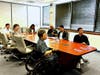 Everyone listened to Ms. Lewi's presentation in the conference room.