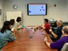 Delegate Julie Palakovich Carr listened to presentations by Ms. Rita and the heads of various divisions in the conference room.