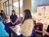 Ms. Kate Lu, Director of CCACC Health Center (left), Ms. Shiyu Huang, Outpatient Coordinator of CCACC Health Center (right) introduced the center's services to community residents.