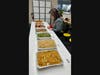 The teacher labeled each dish with Chinese characters and pinyin during lunch.