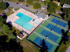 Aerial view of CCACC Sports swimming pool and tennis facilities.