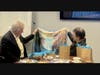 Ms. Lewi (Executive Director of CCACC) presented former U.S. Congressman for Maryland David Trone with a silk scarf featuring her oil painting design.