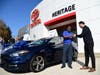 Heritage Toyota Owings Mills Manager John Kim presents the key to a 2013 Dodge Dart to U.S. Navy veteran Kenneth Thomas.