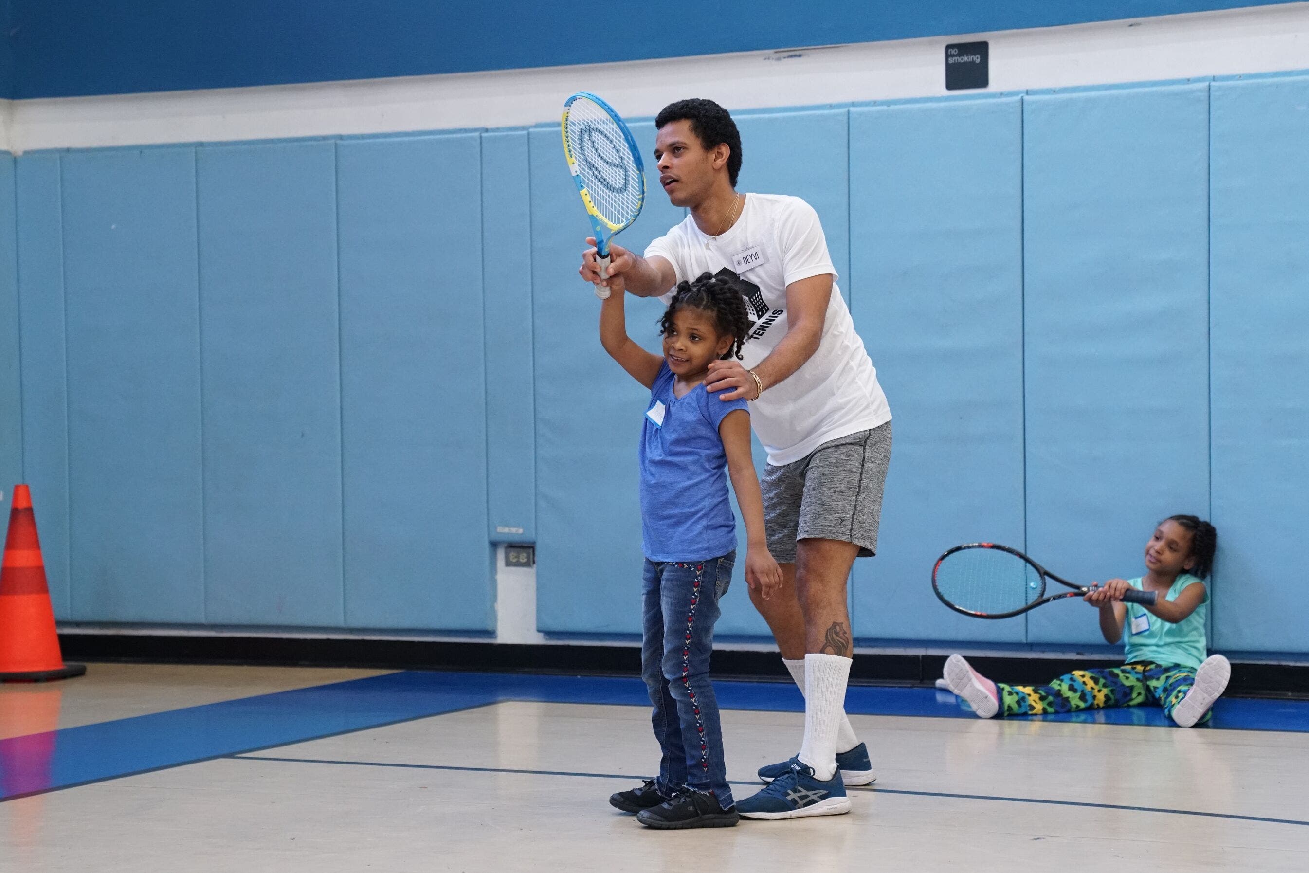 Instructor with tennis student.