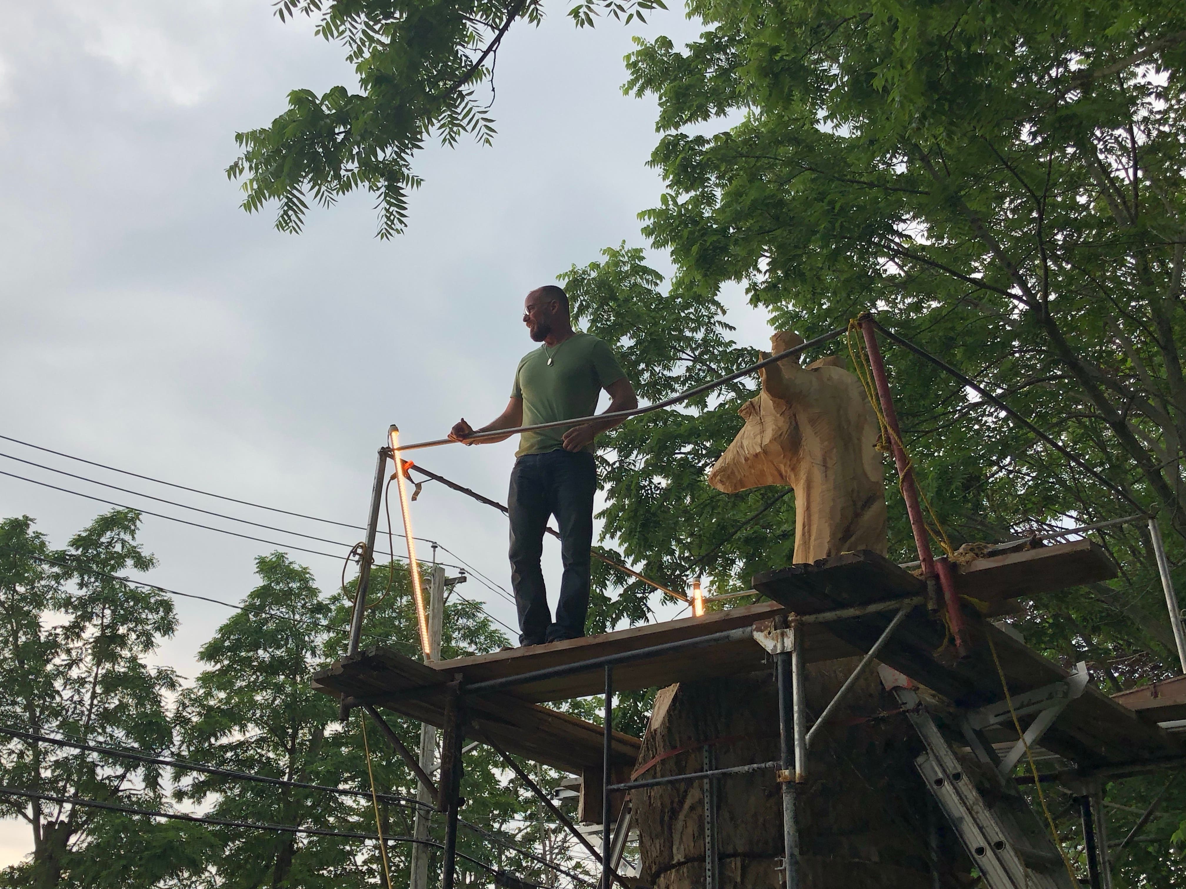 Arnett standing at the top of his giraffe workspace.