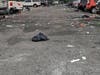 The parking lot of the Long Island Community Amphitheater was left littered with trash after a night of live music.