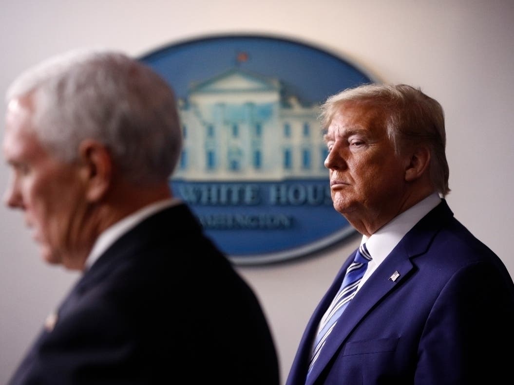 President Donald Trump listens as Vice President Mike Pence speaks during a coronavirus task force briefing at the White House.