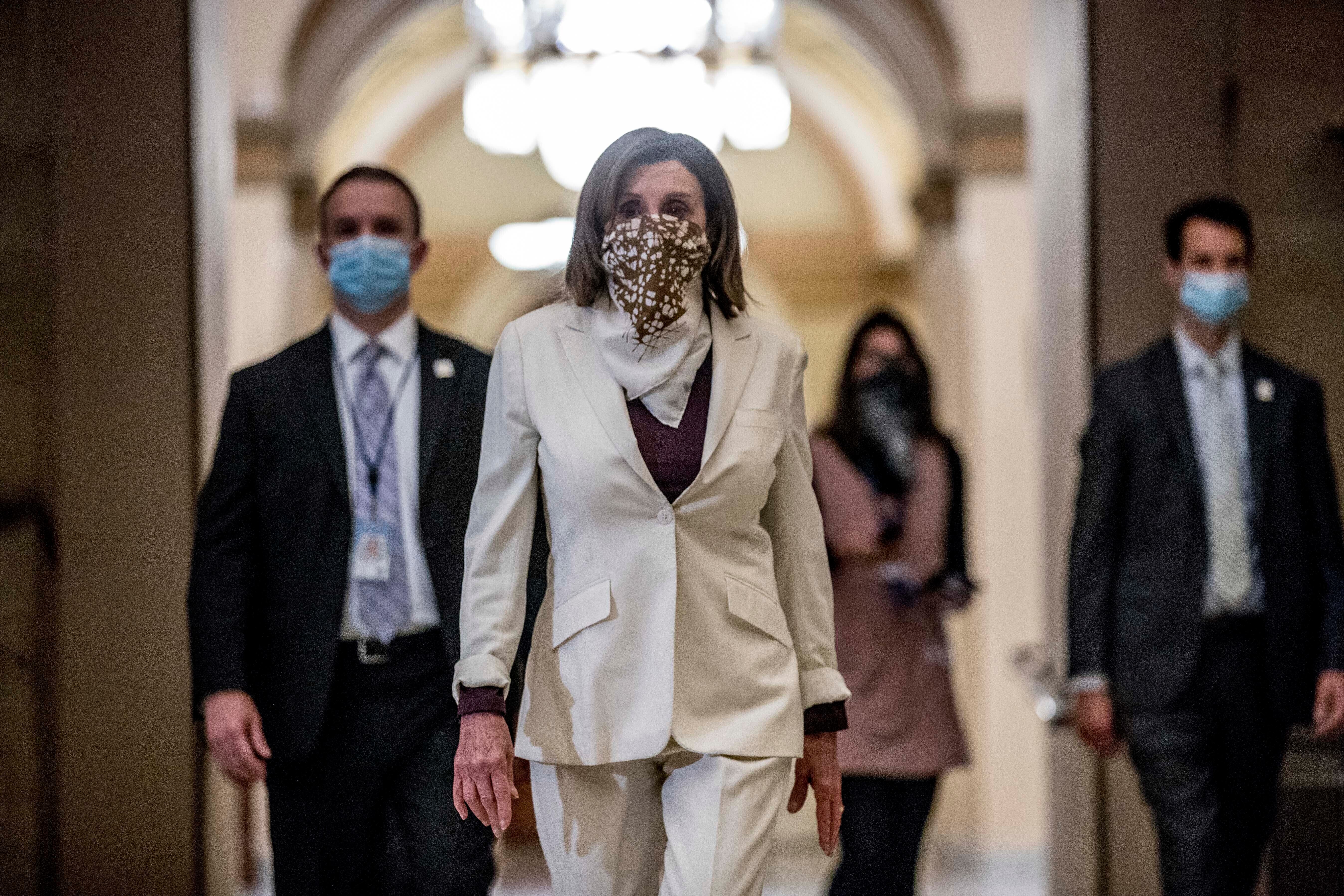 House Speaker Nancy Pelosi walks to her office after signing the Paycheck Protection Program and Health Care Enhancement Act, H.R. 266, after it passed the House. (AP Photo/Andrew Harnik)