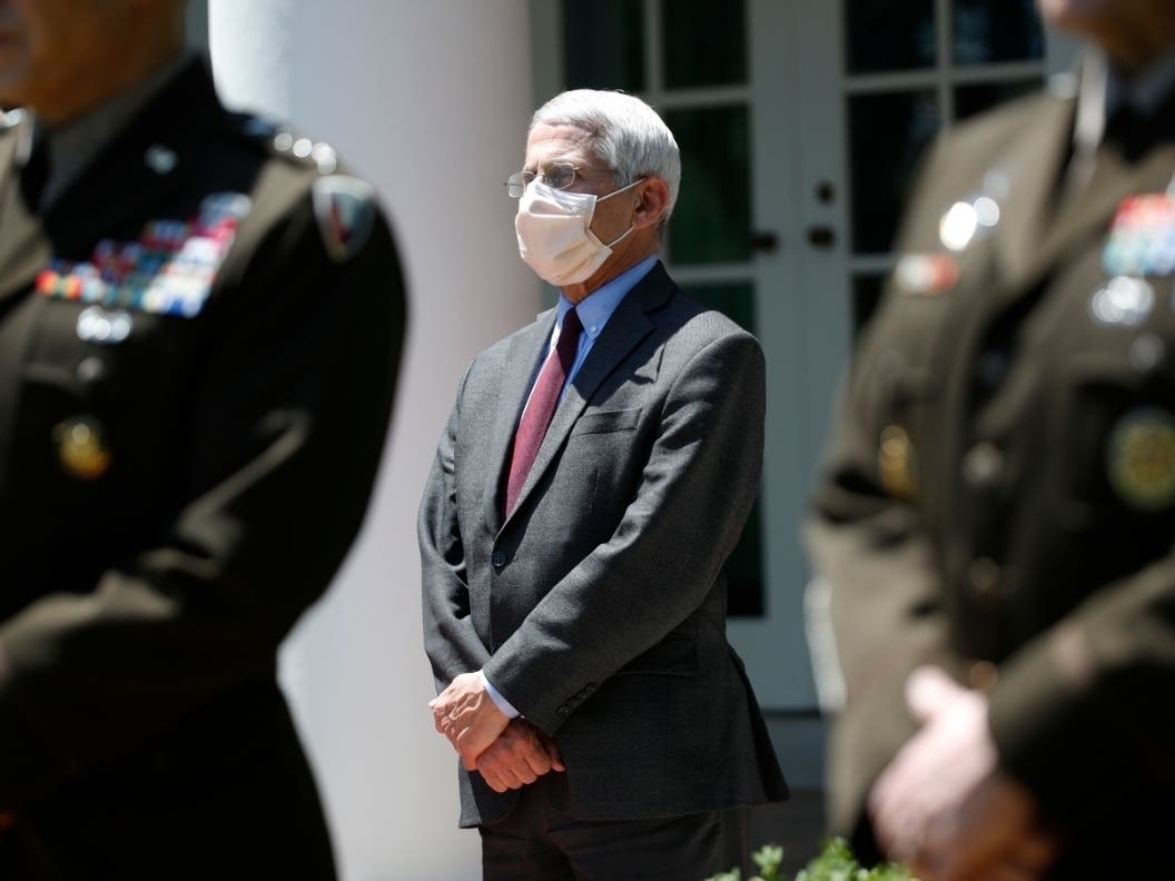 Dr. Anthony Fauci, director of the National Institute of Allergy and Infectious Diseases, listens as President Donald Trump speaks about the coronavirus in the Rose Garden of the White House