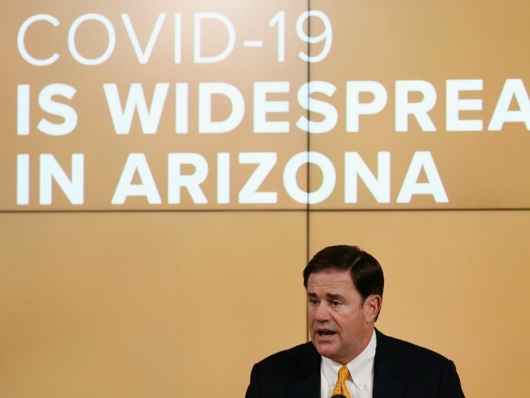 Arizona Republican Gov. Doug Ducey speaks about the latest coronavirus data at a news conference.