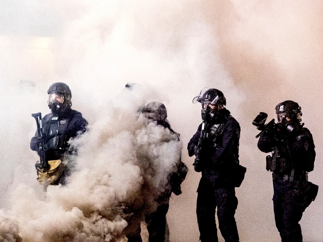 Federal officers use chemical irritants and projectiles to disperse Black Lives Matter protesters in Portland, Oregon. 