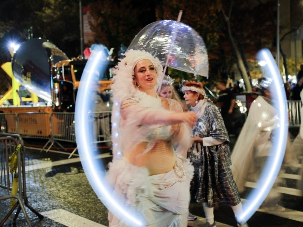 Parade goers make their way down the street during the NYC Village Halloween Parade. 