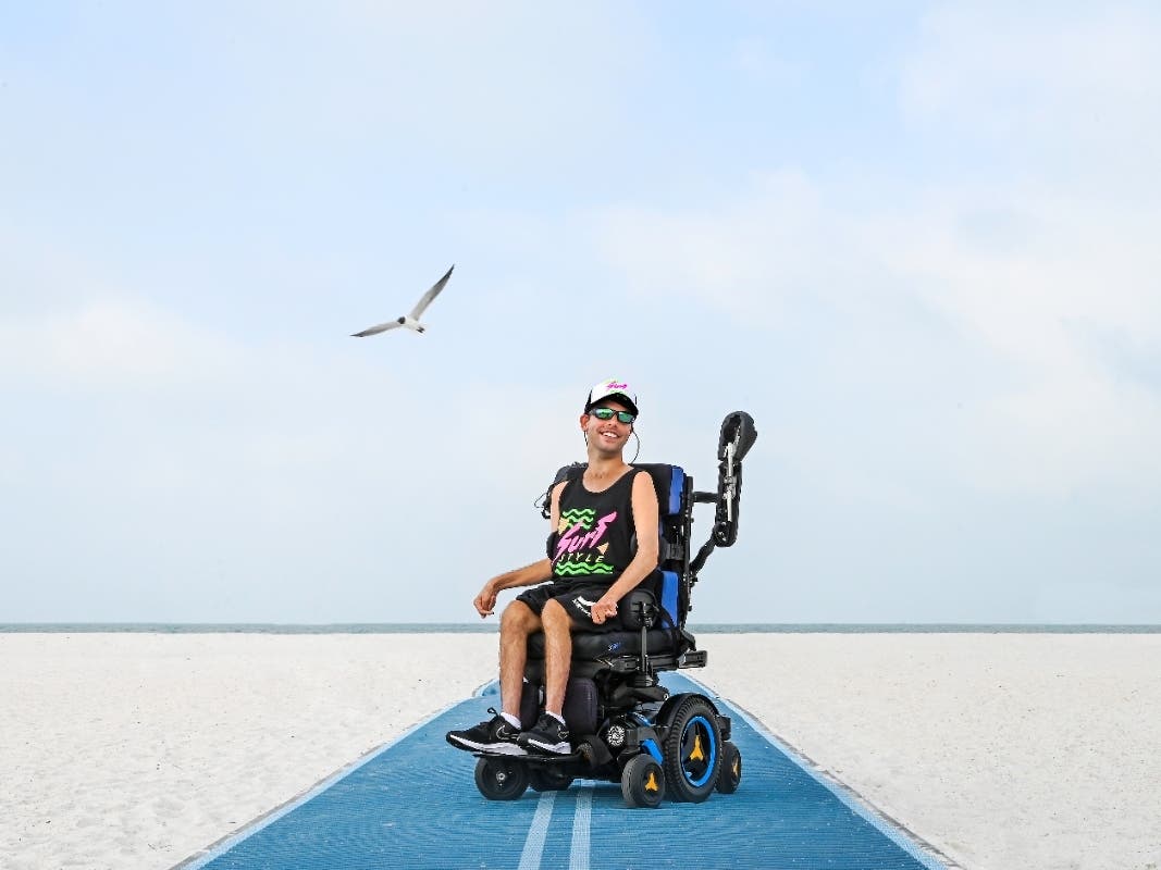 Andrew Brettner models in Surf Style clothing on the mobility mat at Treasure Island Beach. 