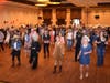 Line dancing guests filled the dance floor in front of silent auction tables filled with prizes to be won.