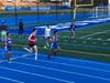 " And Down The Stretch They Come ! "  Bunnells Mario Oliva and Pomperaug's Benjamin Kania with less than 100 meters to go in the 3200 Meter race. Kania out paced Oliva by 86 hundredths of a second,  10:48.02 to 10:48.86.  