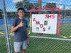 Stratford's Amos Colocho stands next to a poster made in celebration of his last career home race during senior night festivities on September 28th. 