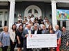 Red Bank Charter School students, Head of School Kristen Martello (front row, third from left) and Mayor Pasquale Menna (fourth from left) join YMCA representatives in accepting a $10,000 donation from the Red Bank Classic.