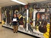 Michael Schwartz, Great Neck South's Music Director accepts his certificate in front of the Music mural