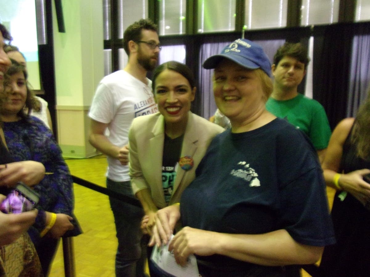 Rep. Alexandria Ocasio Cortez and Lisa McCormick on the campaign trail together, joined by other progressive activists, before the coronavirus made group events impractical.