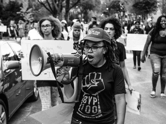 Organizers from BYP100 march in a protest.