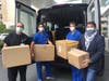 Dr. Farrukh Jafri, Dr. Rafael Torres, Dr. Dean Straff and Million Air CEO Roger Woolsey unload boxes of masks at White Plains Hospital.