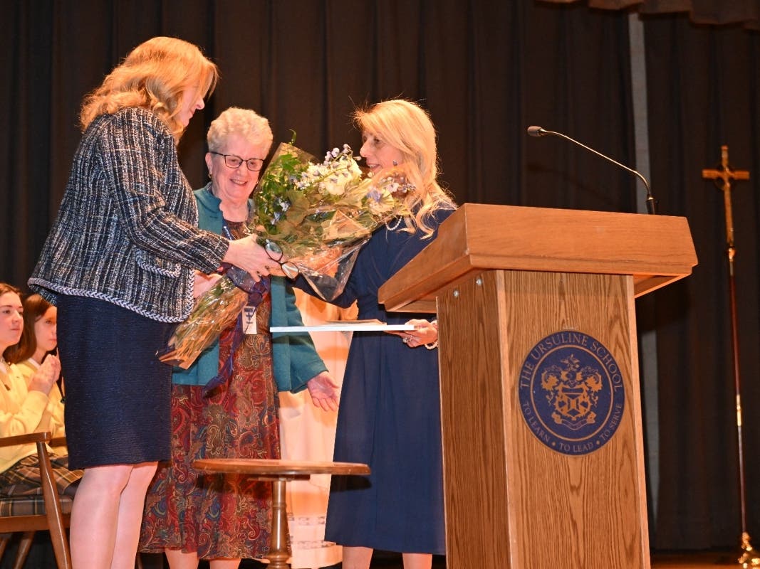 Ursuline School President presents flowers to new Principal Theresa Napoli 