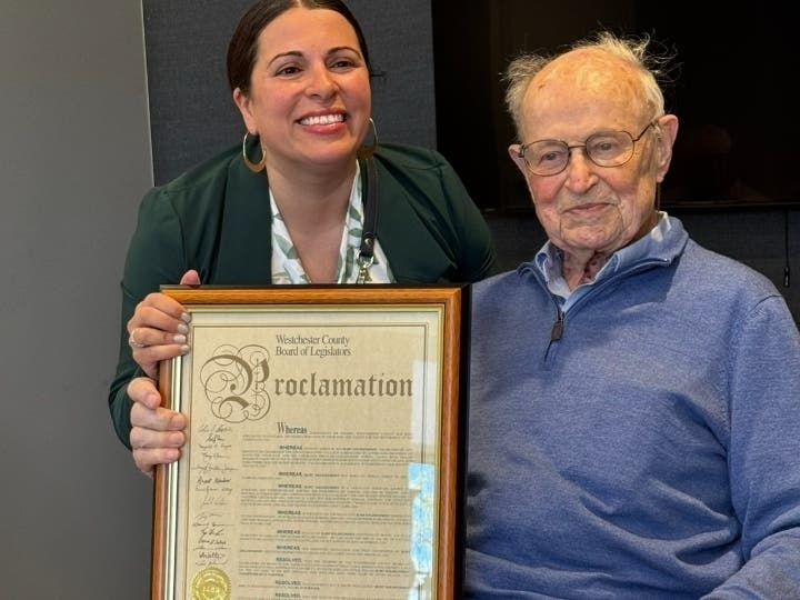 Westchester County Legislator Jen Puja presents proclamation to Kurt Goldschmidt 