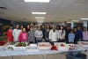 East Woods School students, staff and family members pose near their chopped peppers which are soon to be stuffed.