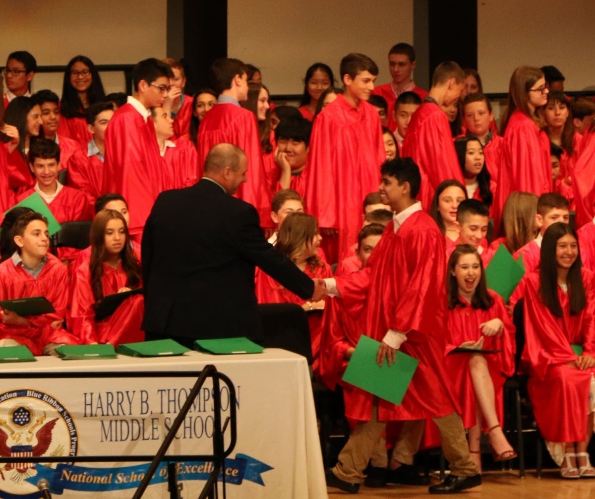 Principal Kevin Bonanno congratulates an eighth grade graduate.