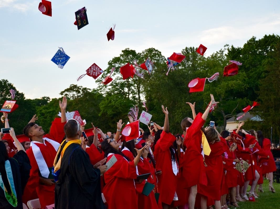 Glen Cove High School students tossed their caps to mark the conclusion on their graduation.