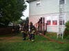 Firefighters work to extinguish the fire at the Hicksville home.
