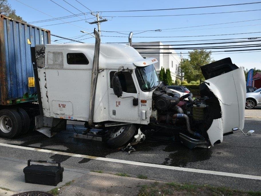 The tractor trailer collided with a car in Plainview on Thursday.