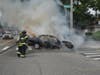 Plainview fire fighters work to extinguish the flames of the car that was on fire.