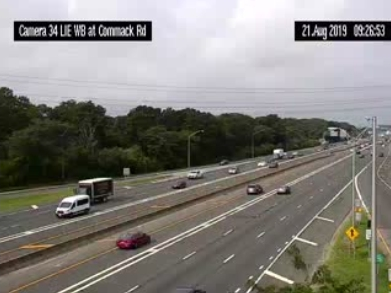 Traffic heads westbound on the I-495, driving towards the disabled tractor trailer. 