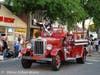 Leading the parade are Grand Marshal Don Natiello being driven by Al More in the Greenlawn Fire Department antique fire engine.