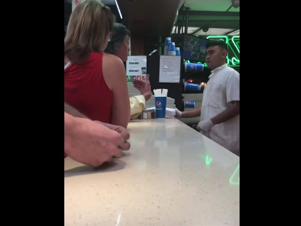 A customer argues with a worker at Little Vincent's Pizza in Huntington. 
