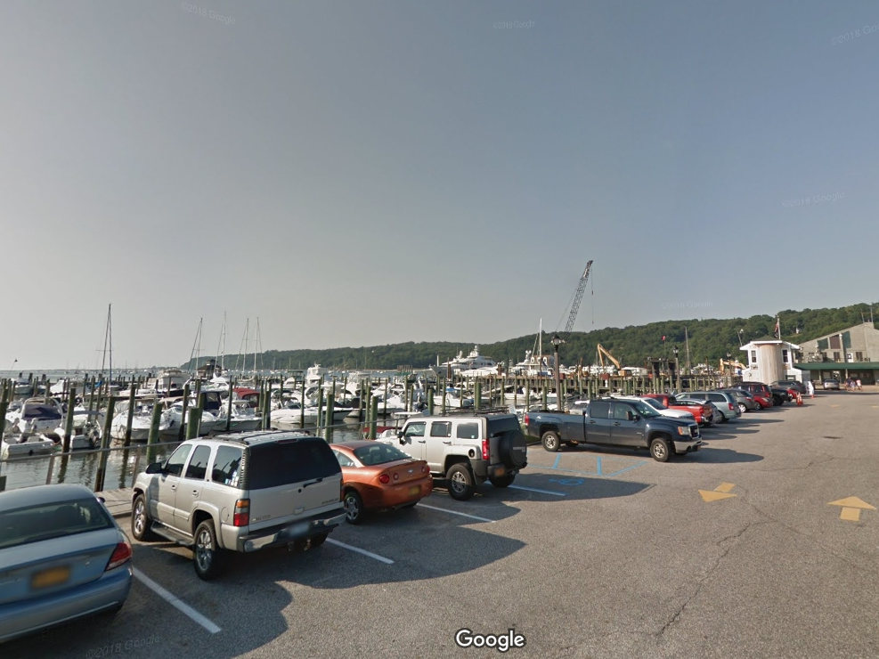 A woman fell off a floating dock at Port Jefferson Marina Friday afternoon and was rescued by Suffolk County Marine Bureau officers.