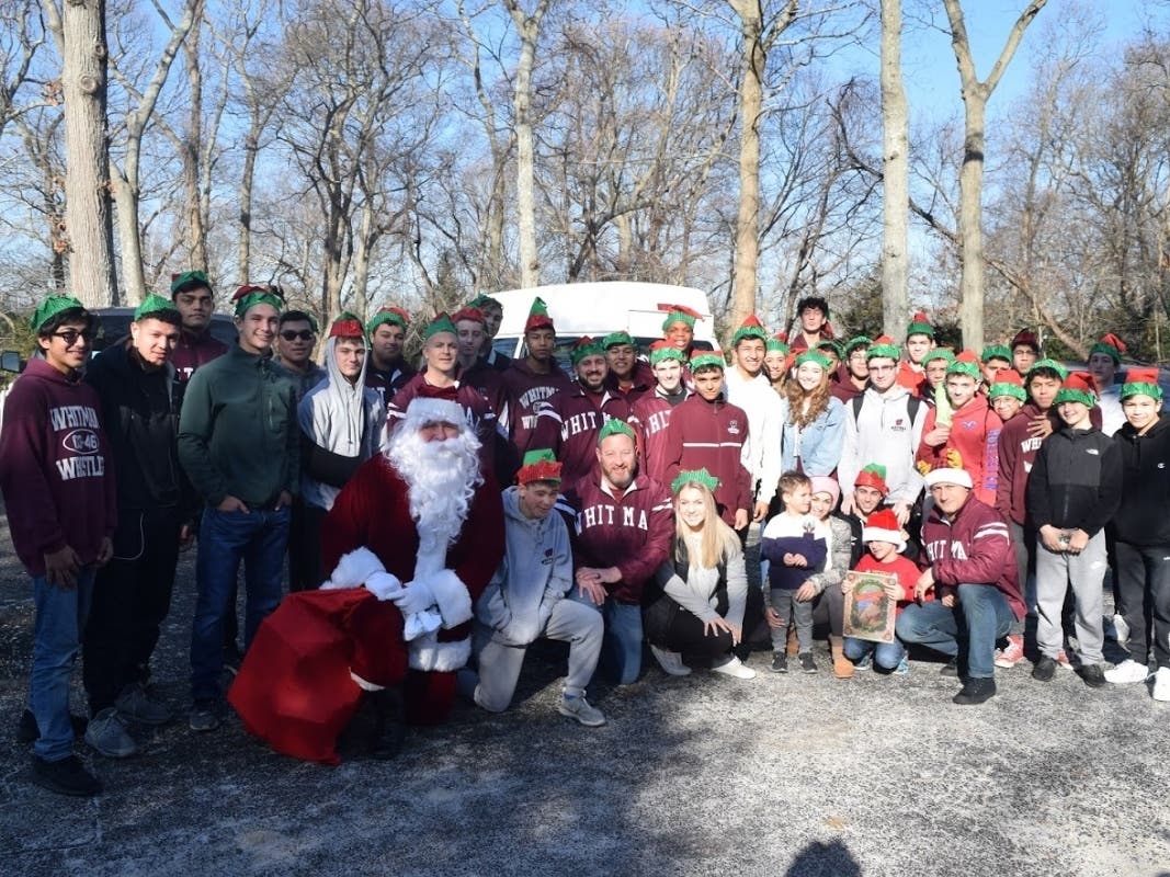 The Walt Whitman High School wrestling team, representing South Huntington, visited children at Angela's House to spread holiday cheer.