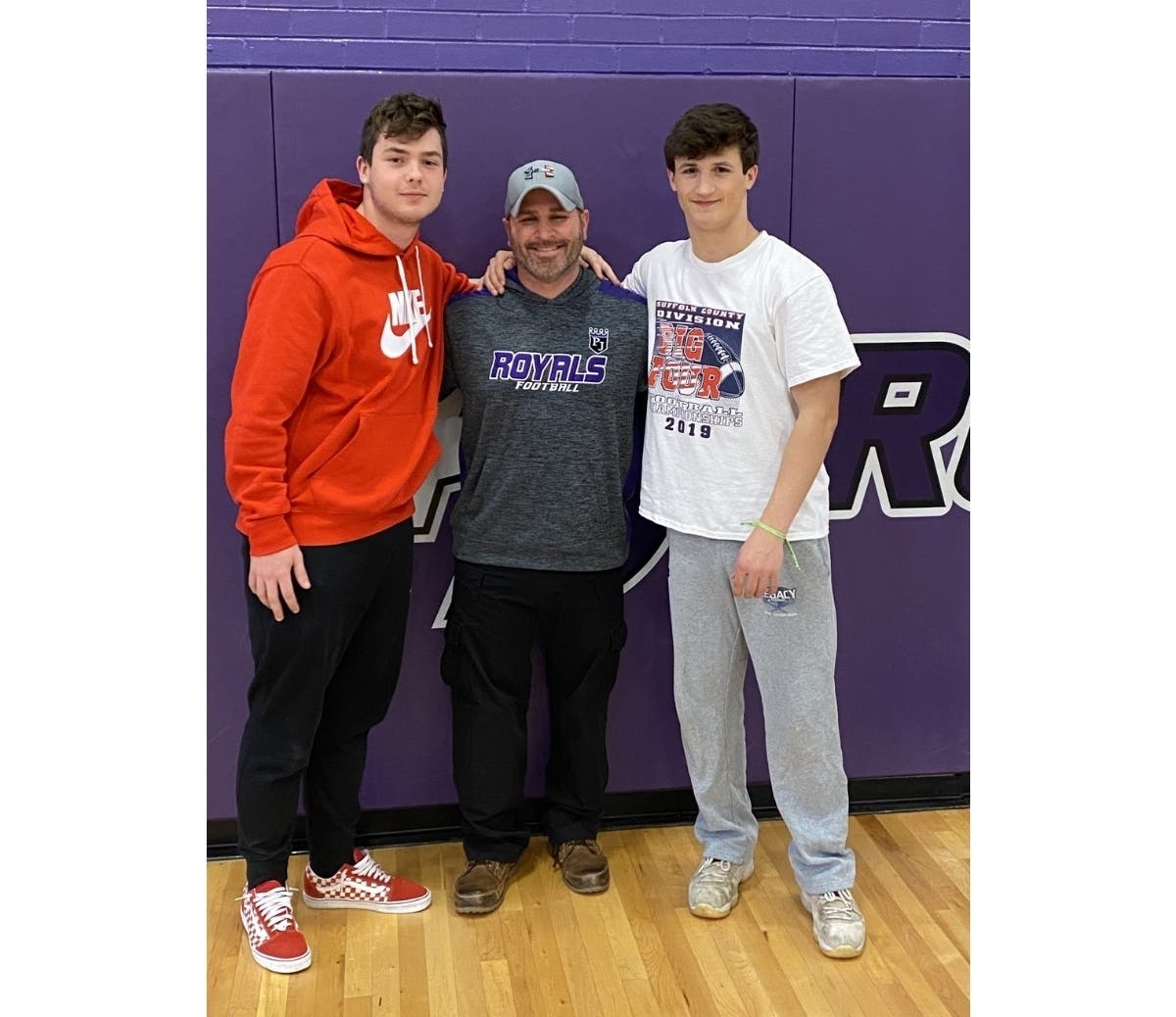 Earl L. Vandermeulen High School students Sam Florio (left) and Aidan Kaminska flanked coach Andrew Cosci.