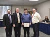 L-R: District Chairperson of Science, Technology and Engineering Education David Storch, Superintendent Robert Banzer, Technology and Engineering Student of the Month Ryan Heinzman and Board of Education President David Badanes.